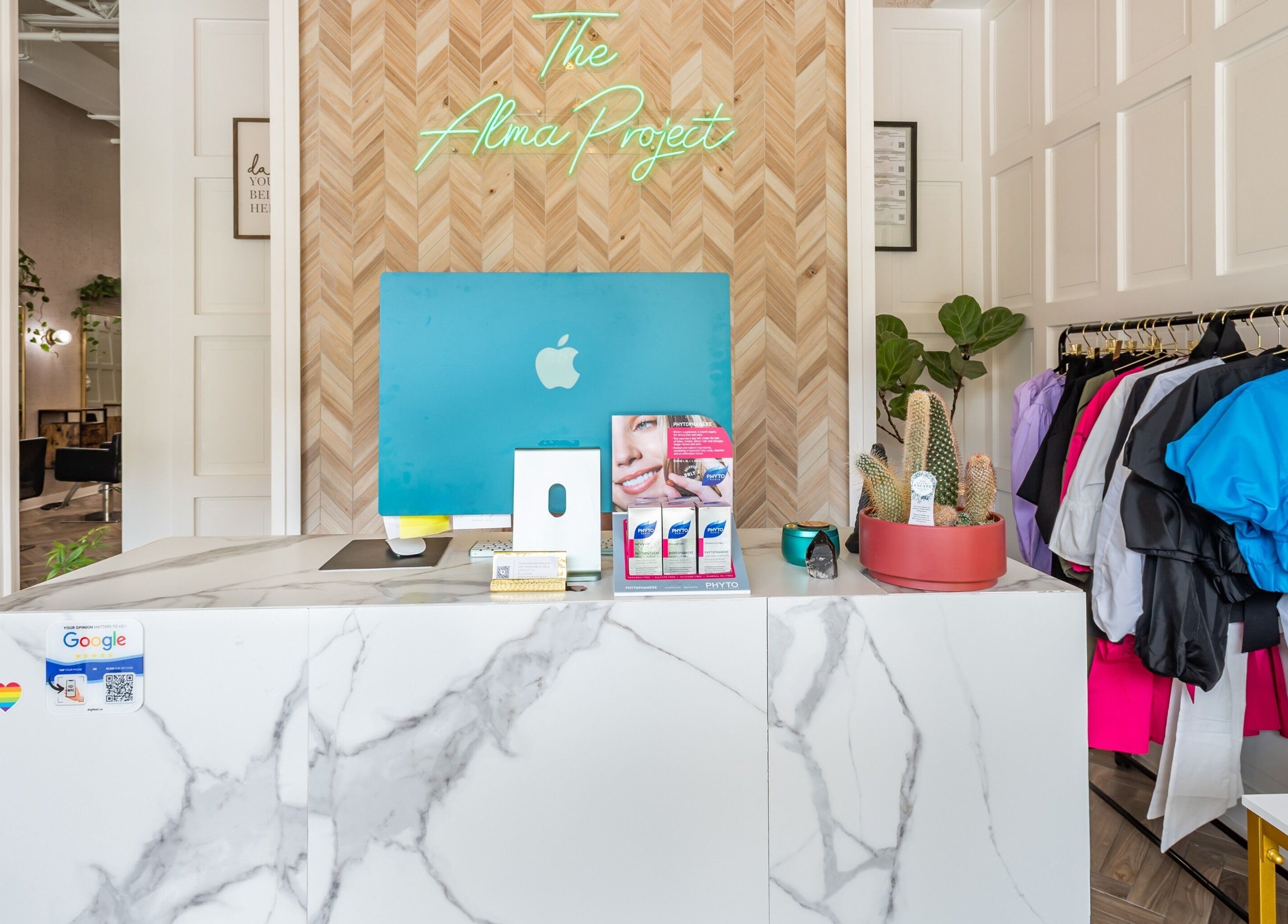 Reception area of The Alma Project by AG in Boca Raton, Florida, US, featuring a stylish marble desk and elegant decor.