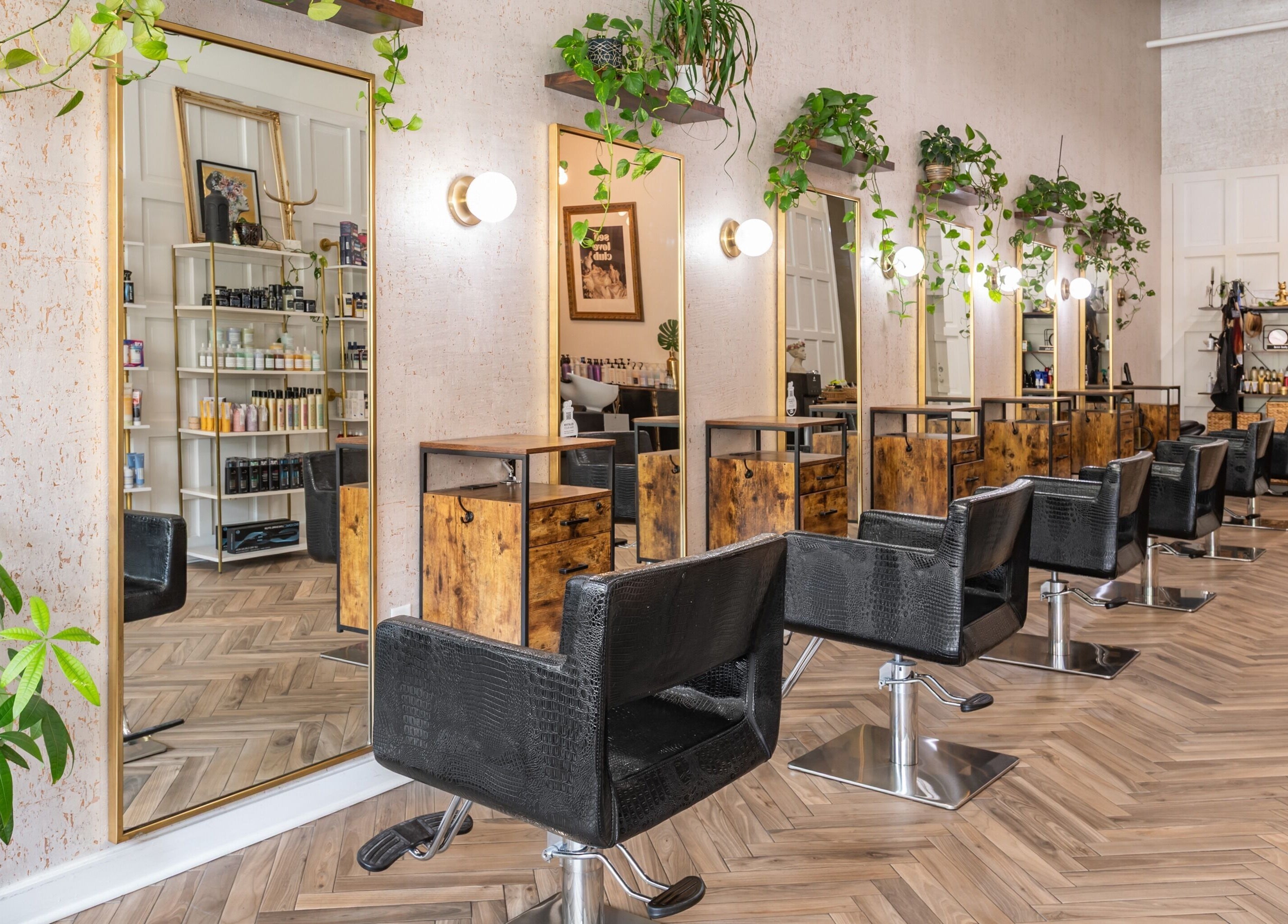 Elegant salon area at The Alma Project by AG, Boca Raton, Florida, US with stylish chairs and mirrors.