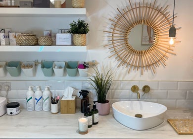 Calming vanity space at Beauty + Wellness by Faye Jervis, Sheffield, England, GB with natural decor and essentials.