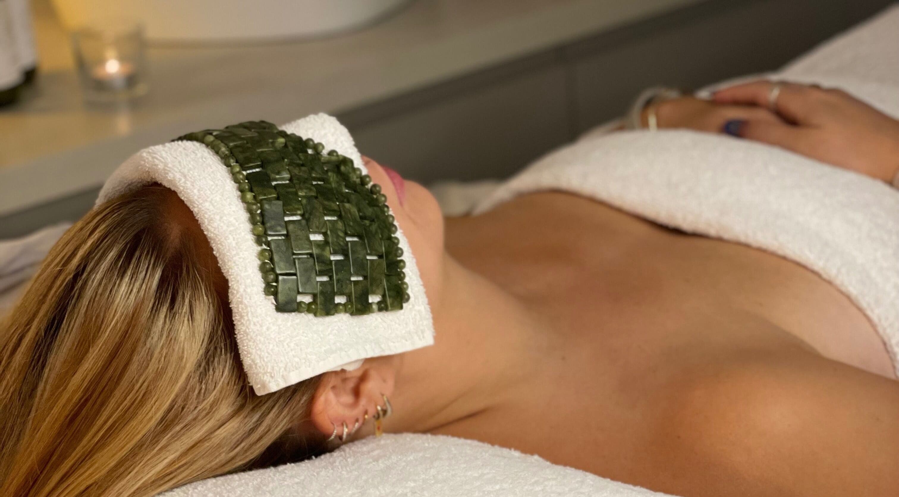 Client enjoying spa treatment at Beauty + Wellness by Faye Jervis, Sheffield, England, GB with jade eye mask.