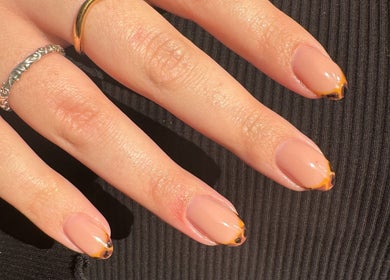 Chic nail design with orange tips at Aurae London - Nail Artistry & Beauty, Romford, England, GB.