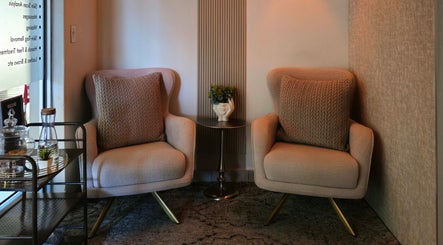 Luxurious seating area at Rolia Day Spa Ondangwa, Ondangwa, Oshana Region, NA with plush armchairs and a side table.