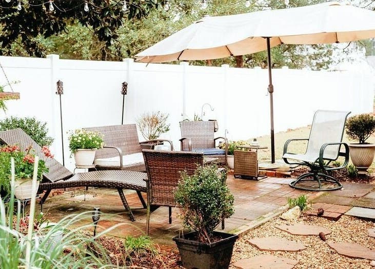 Outdoor seating area at Hair Loft on Linden, Pinehurst, North Carolina, US with cozy chairs and umbrella.