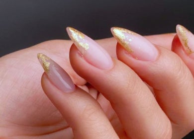 Golden tipped nails elegantly displayed at Beauty Additions in Sandton, Gauteng, ZA, showcasing stylish nail art.