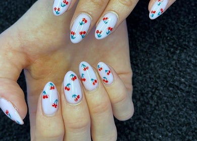 Cherry nail art design at Beauty Additions in Sandton, Gauteng, ZA. Perfectly manicured hands with cherry patterns.