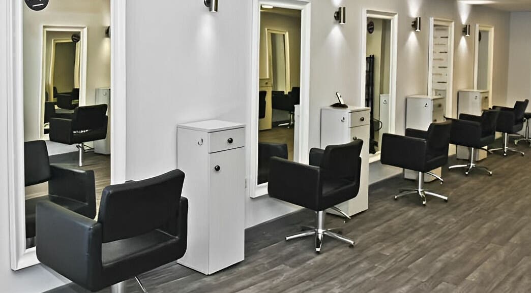 Sleek salon chairs and mirrors at Innovation, Saint Helens, England, GB. Modern design for a relaxing experience.