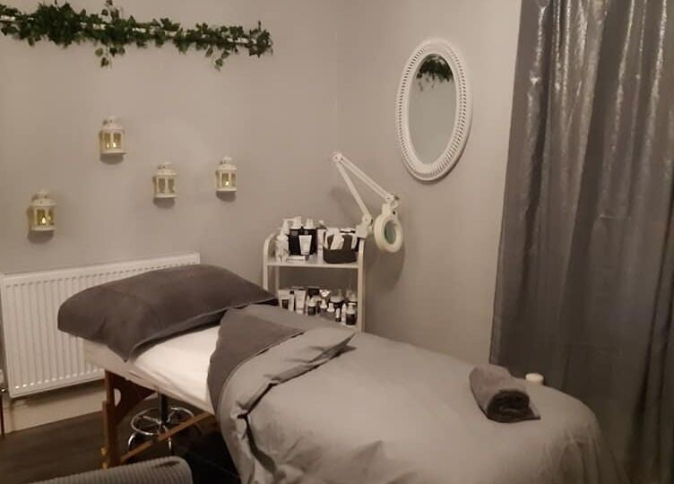 Relaxing treatment room at Innovation, Saint Helens, England, GB, featuring a cozy bed and elegant decor.