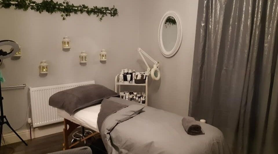 Relaxing treatment room at Innovation, Saint Helens, England, GB, featuring a cozy bed and elegant decor.