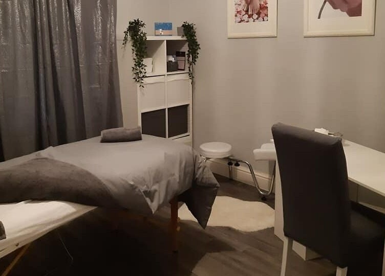 Tranquil spa room at Innovation, Saint Helens, England, GB, featuring a massage table and calming decor.