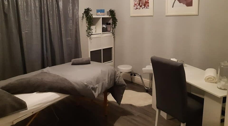 Tranquil spa room at Innovation, Saint Helens, England, GB, featuring a massage table and calming decor.