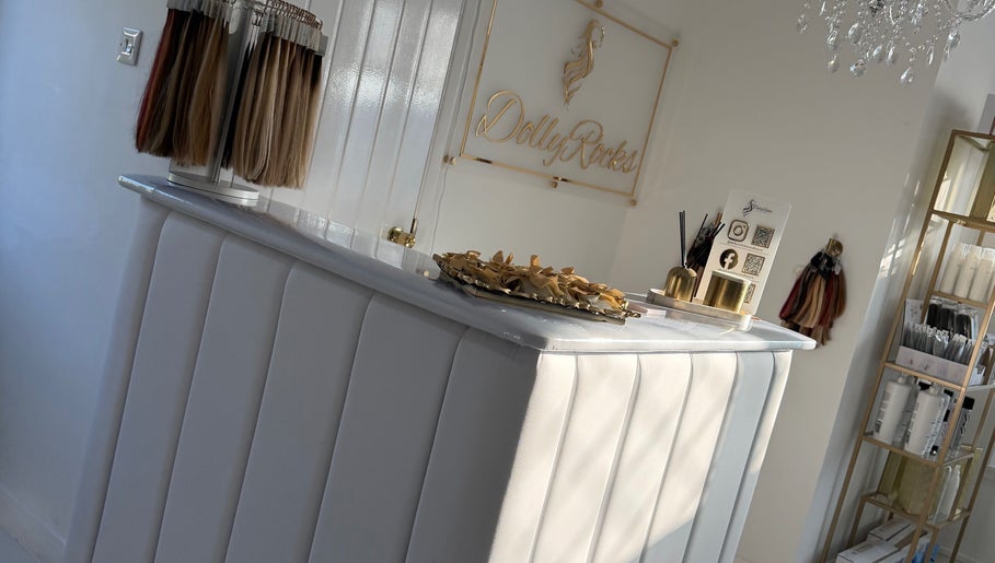 Reception area at Dolly Rocks Hair & Beauty, Gorseinon, Wales, GB featuring stylish decor and hair samples display.