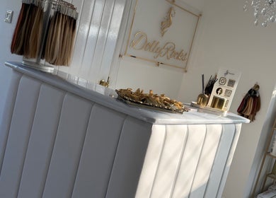 Reception area at Dolly Rocks Hair & Beauty, Gorseinon, Wales, GB featuring stylish decor and hair samples display.