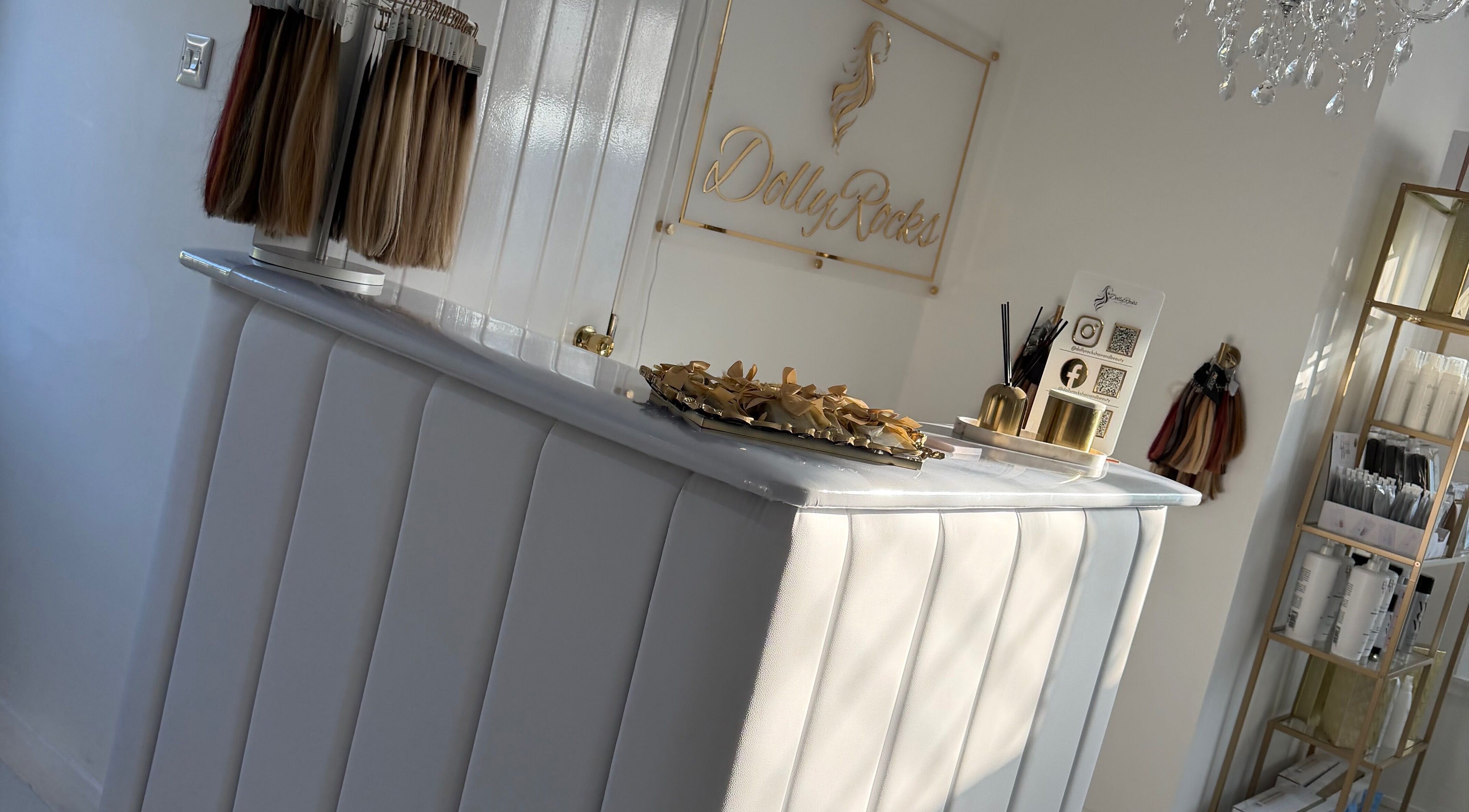 Reception area at Dolly Rocks Hair & Beauty, Gorseinon, Wales, GB featuring stylish decor and hair samples display.