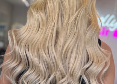 Blonde wavy hairstyle at Dolly Rocks Hair & Beauty, Gorseinon, Wales, GB showcasing salon's elegance.