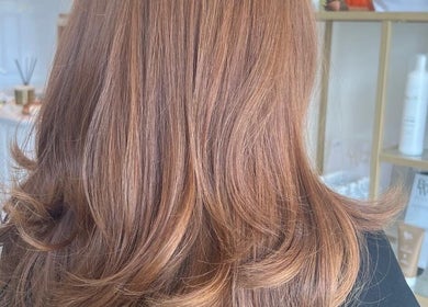 Elegant hairstyle at Dolly Rocks Hair & Beauty, Gorseinon, Wales, GB, showcasing shiny layered waves.