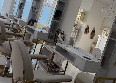 Chic interior at Dolly Rocks Beauty, Aesthetics & Laser in Gorseinon, Wales, GB featuring stylish chairs and mirrors.