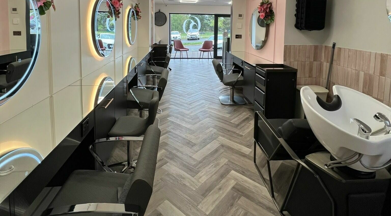 Modern interior of Salon Sixty in Sheffield, England, GB, featuring stylish chairs and mirrors.