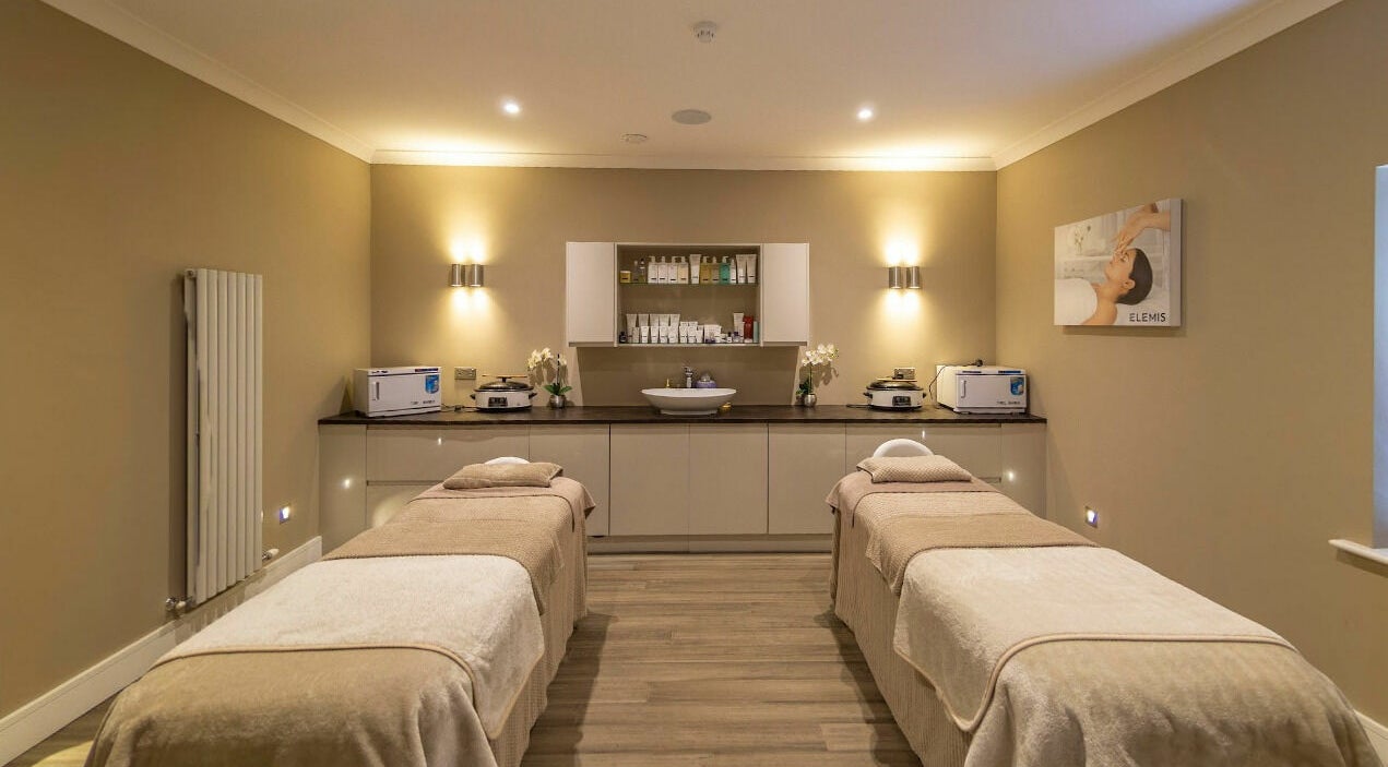 Relaxing treatment room at The King's Spa Day Packages, Onchan, IM, featuring two massage beds and soft lighting.