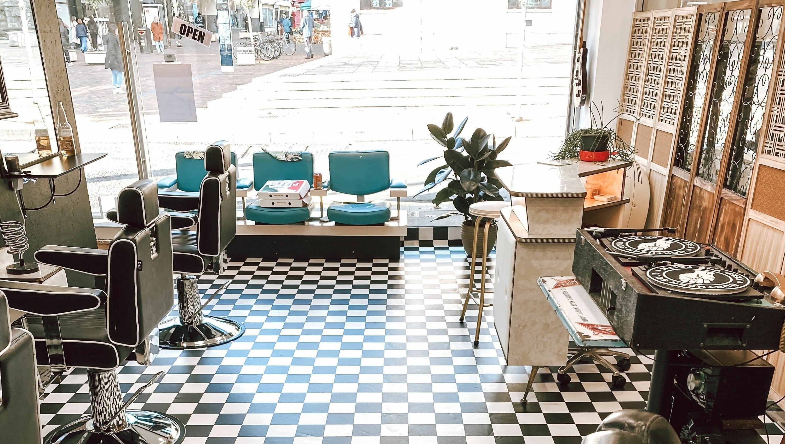 Stylish interior of Hackney Style Council in London, England, GB featuring barber chairs and decor.