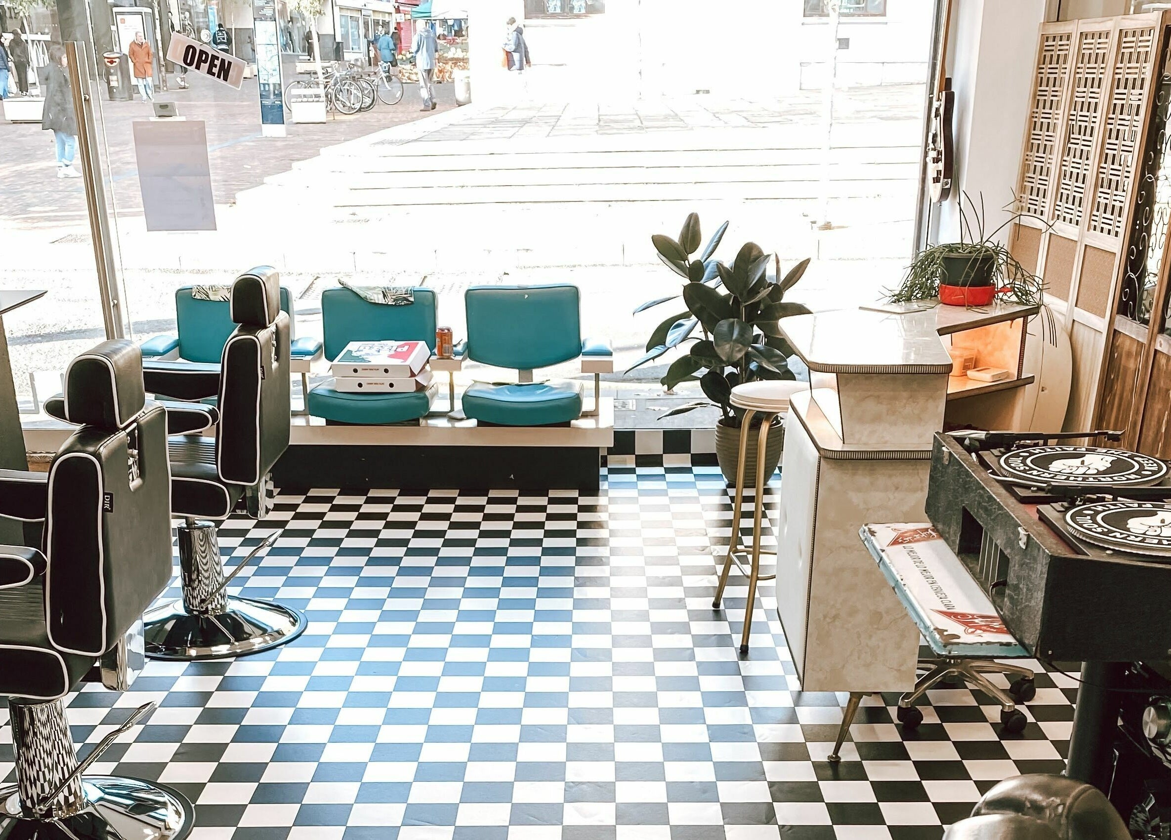 Stylish interior of Hackney Style Council in London, England, GB featuring barber chairs and decor.