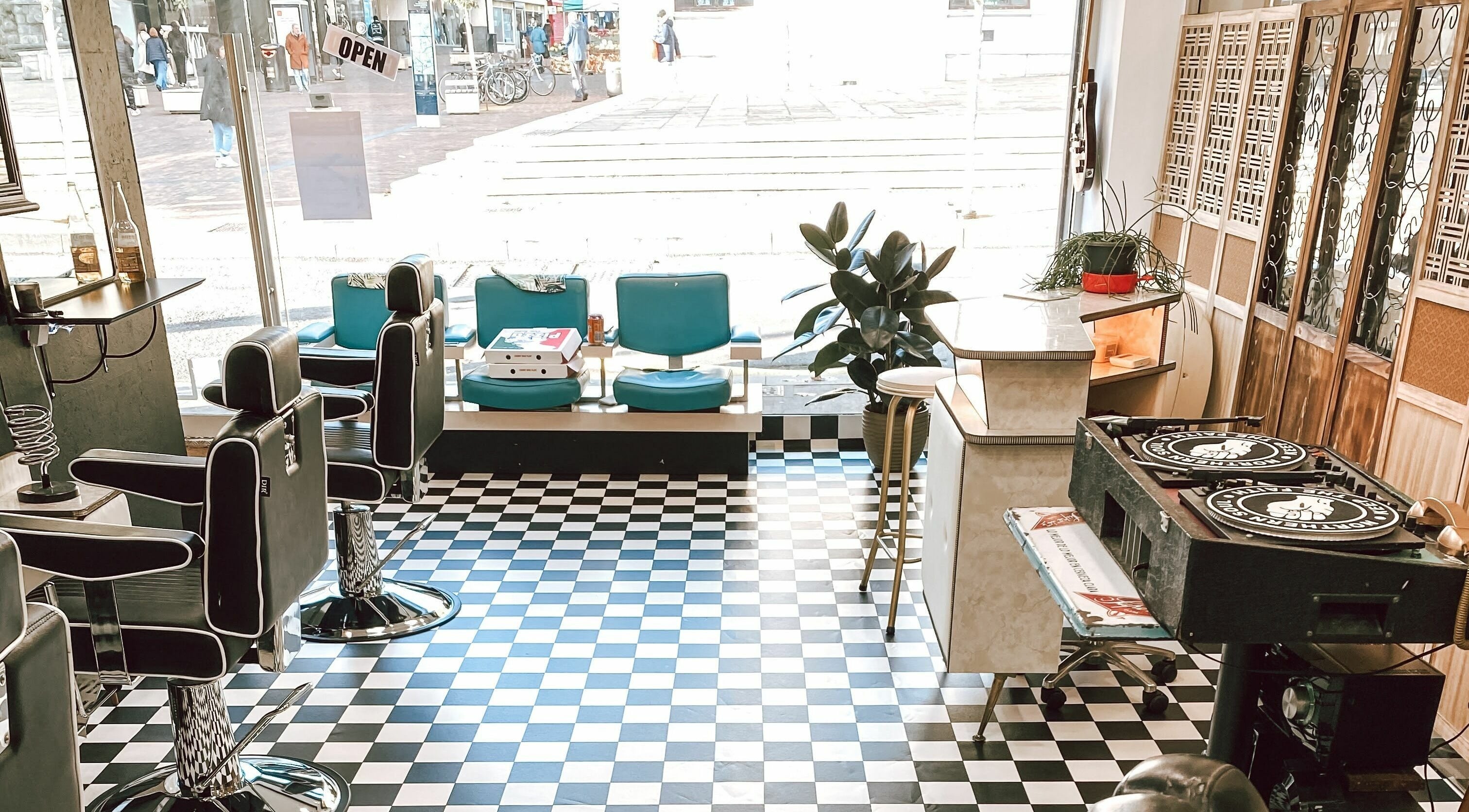 Stylish interior of Hackney Style Council in London, England, GB featuring barber chairs and decor.