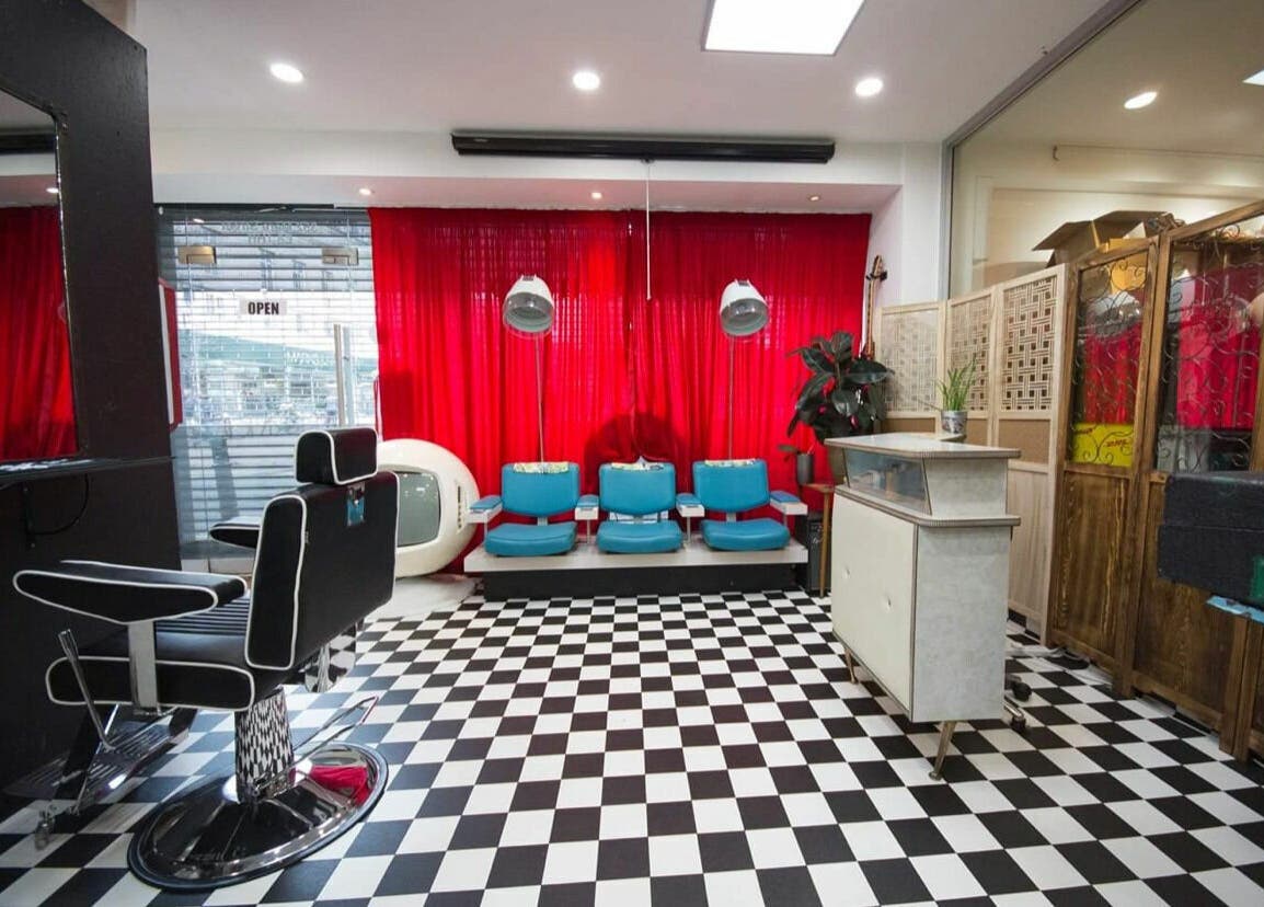 Stylish interior of Hackney Style Council salon in London, England, GB with black and white checkered floor.