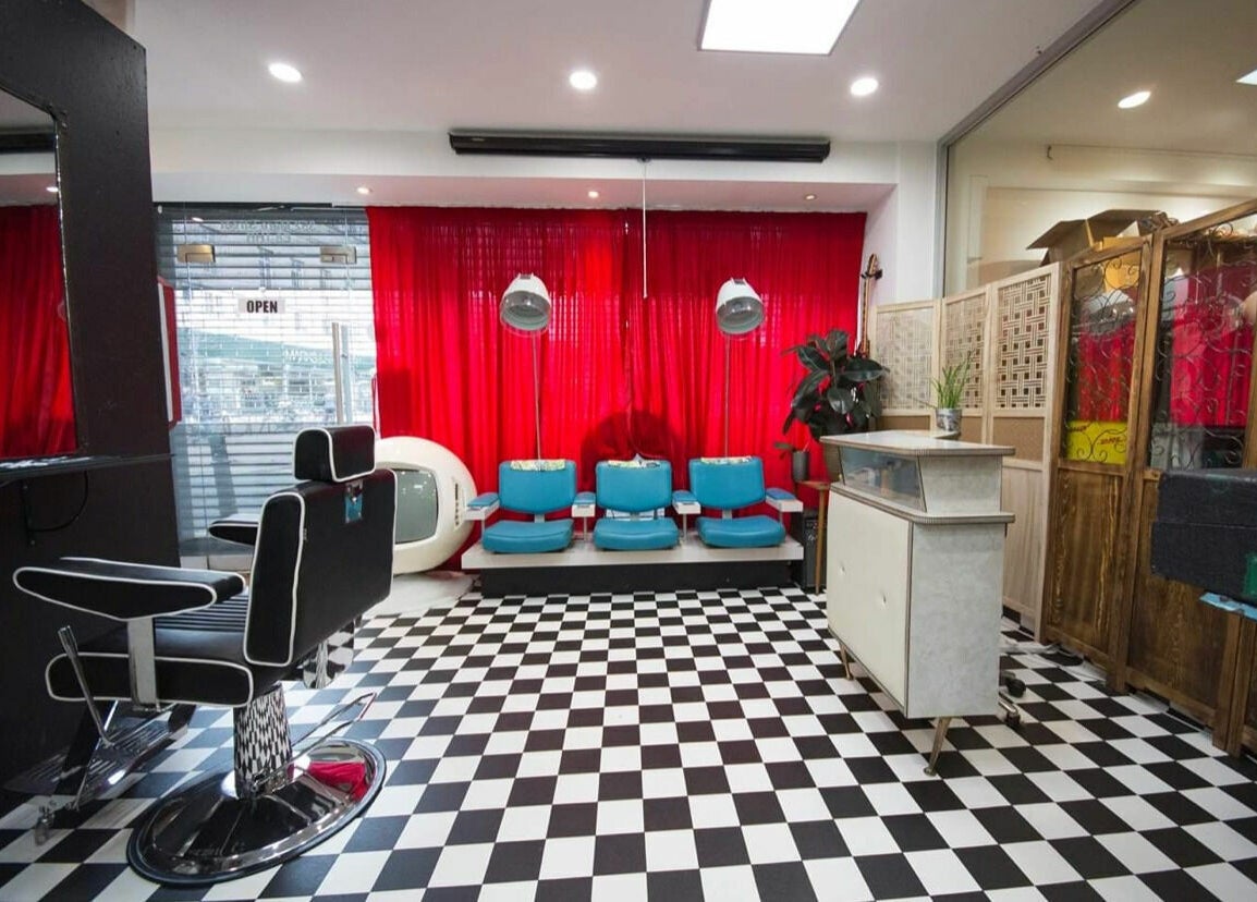 Stylish interior of Hackney Style Council salon in London, England, GB with black and white checkered floor.