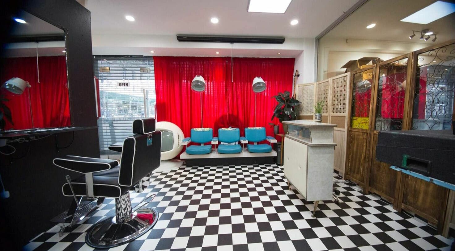 Stylish interior of Hackney Style Council salon in London, England, GB with black and white checkered floor.