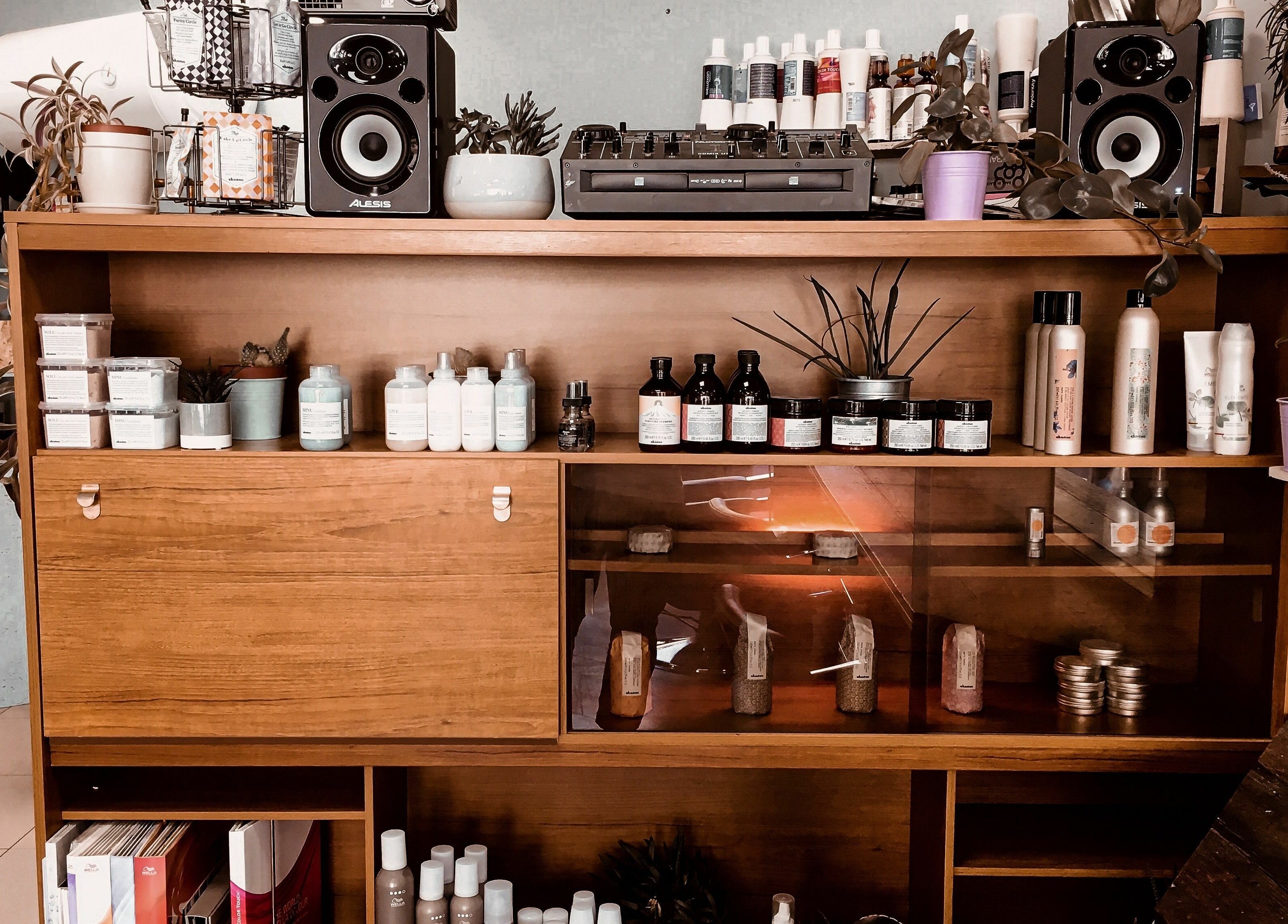 Products on a stylish wooden shelf at Hackney Style Council, London, England, GB, with elegant decor.