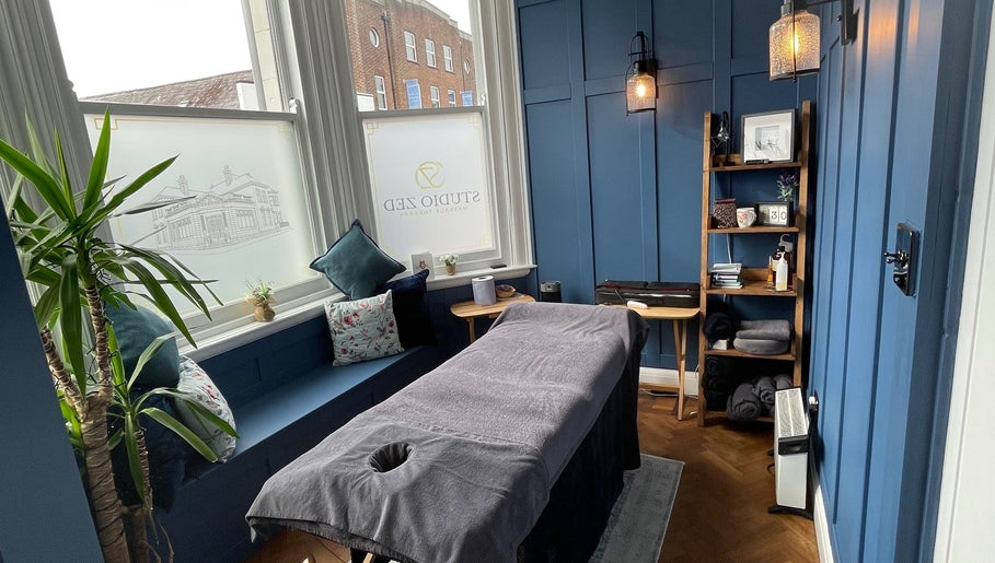 Cozy massage room at Rejuvenate Massage Therapy, Larne, Northern Ireland, GB, featuring serene blue tones.