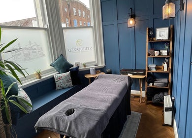 Cozy massage room at Rejuvenate Massage Therapy, Larne, Northern Ireland, GB, featuring serene blue tones.