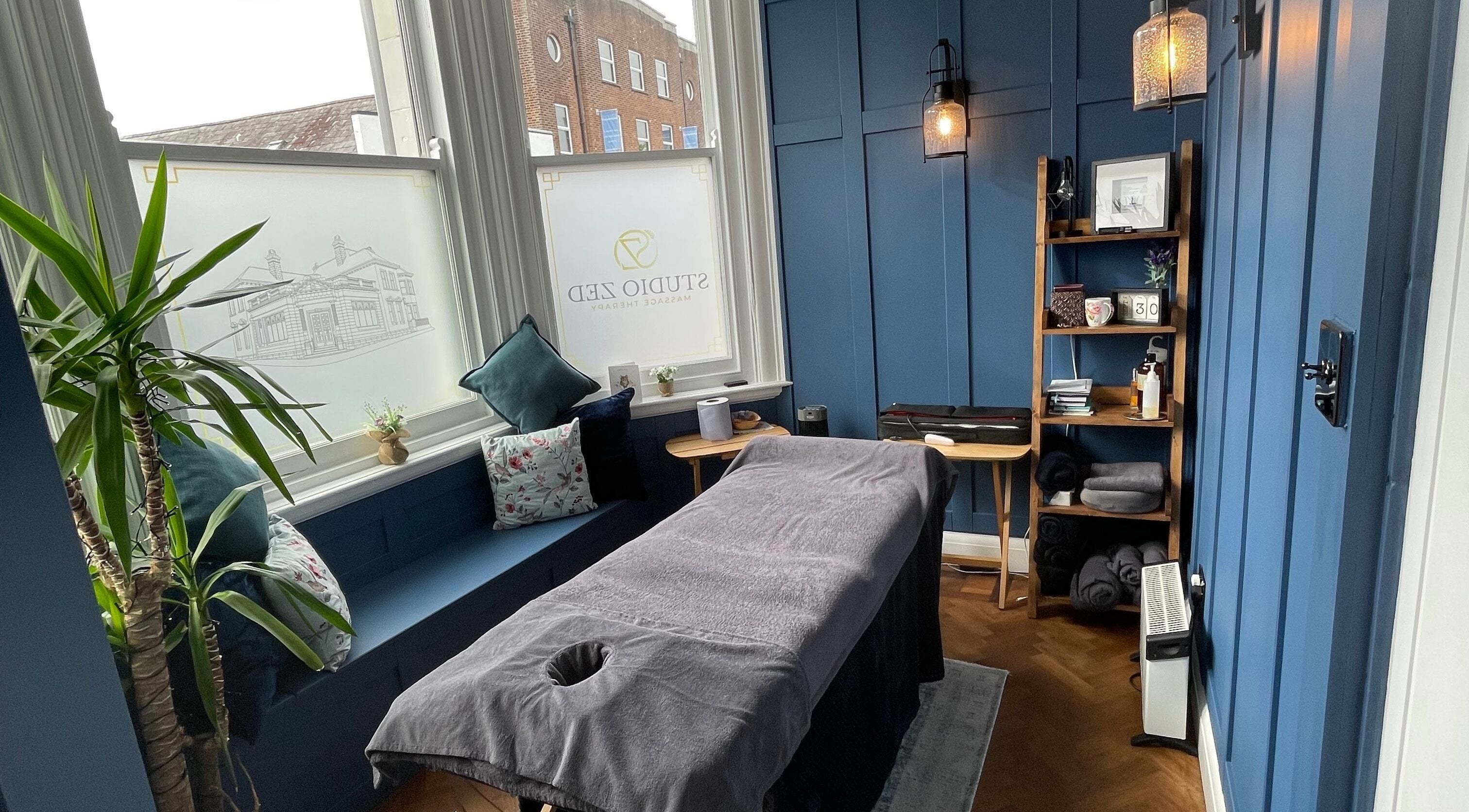 Cozy massage room at Rejuvenate Massage Therapy, Larne, Northern Ireland, GB, featuring serene blue tones.