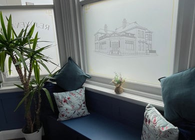 Relaxing seating area at Rejuvenate Massage Therapy, Larne, Northern Ireland, GB, with plants and cushions.