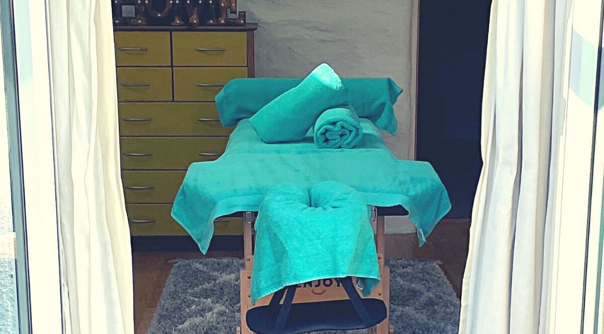 Tranquil massage room at Innovate4Life Massage Therapies (Plymouth), Plymouth, England, GB, with teal decor.