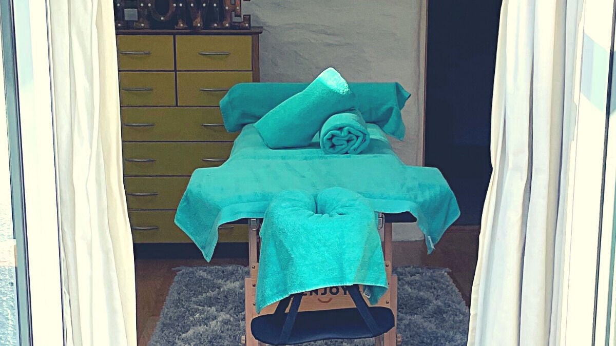 Tranquil massage room at Innovate4Life Massage Therapies (Plymouth), Plymouth, England, GB, with teal decor.