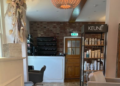 Stylish interior of Alice Olivia Hair in Alcester, England, GB with elegant decor and beauty products.