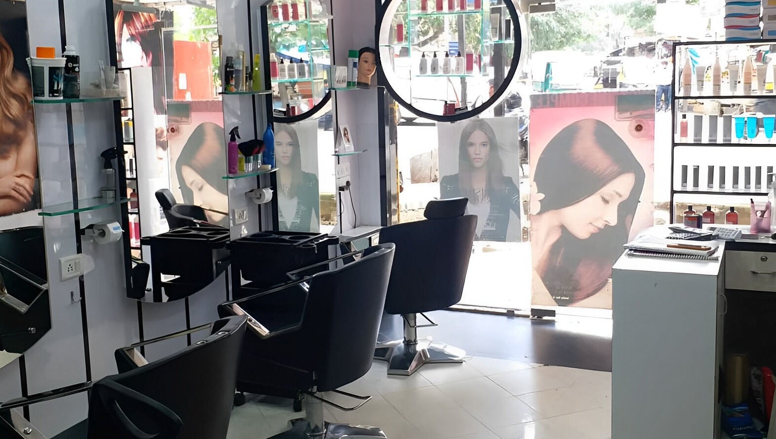 Modern interior of Milon Salon in Mumbai, Maharashtra, IN with stylish chairs and hair products on display.