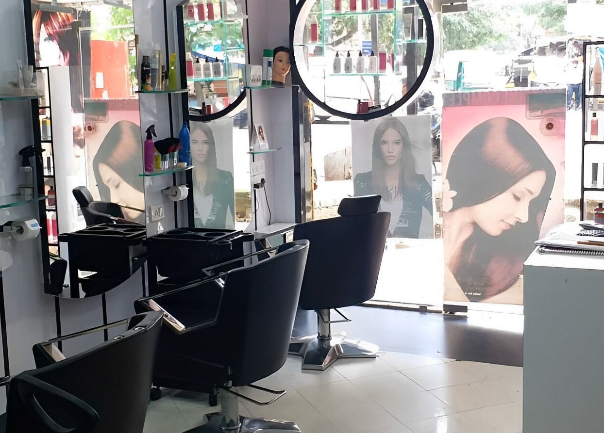 Modern interior of Milon Salon in Mumbai, Maharashtra, IN with stylish chairs and hair products on display.