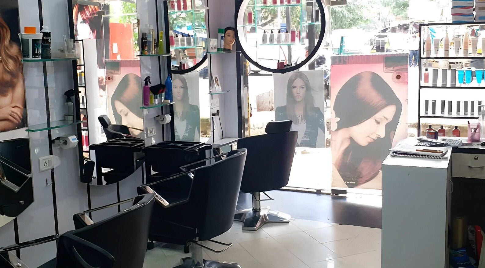 Modern interior of Milon Salon in Mumbai, Maharashtra, IN with stylish chairs and hair products on display.