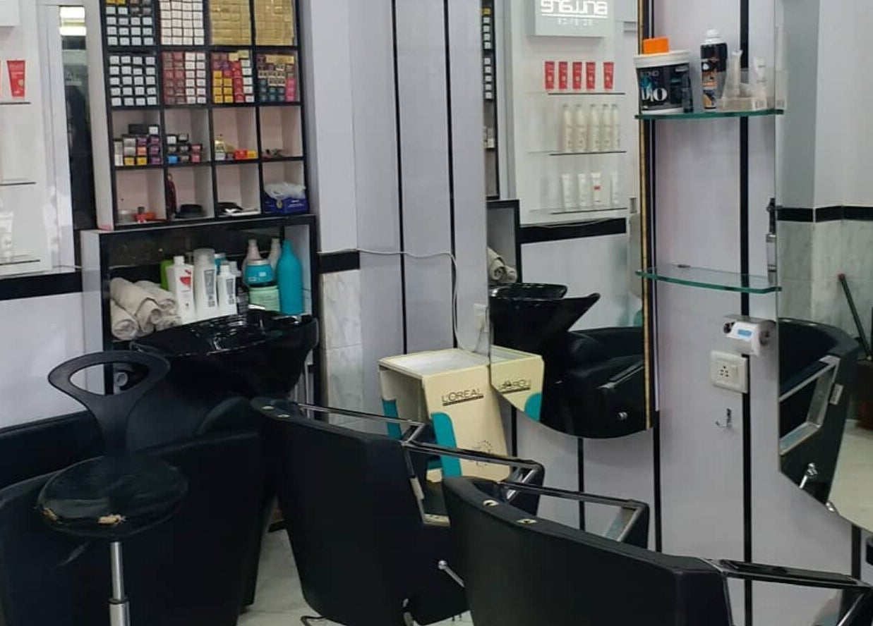 Chic styling area at Milon Salon in Mumbai, Maharashtra, IN with salon chairs and hair care products.