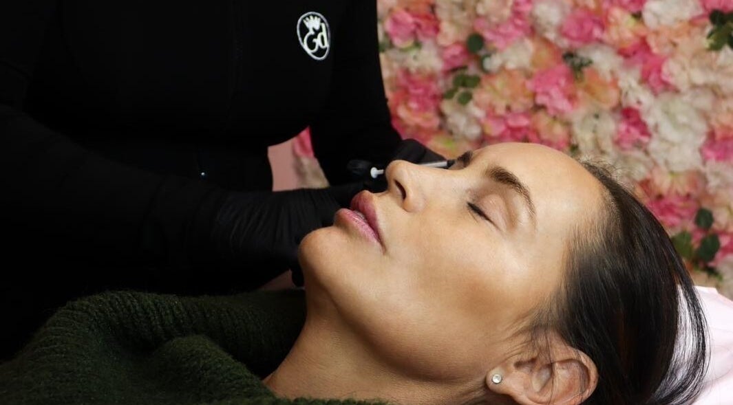 Client receives aesthetic procedure at Elladoons Aesthetics, Smallford, England, GB, enhancing her natural beauty.