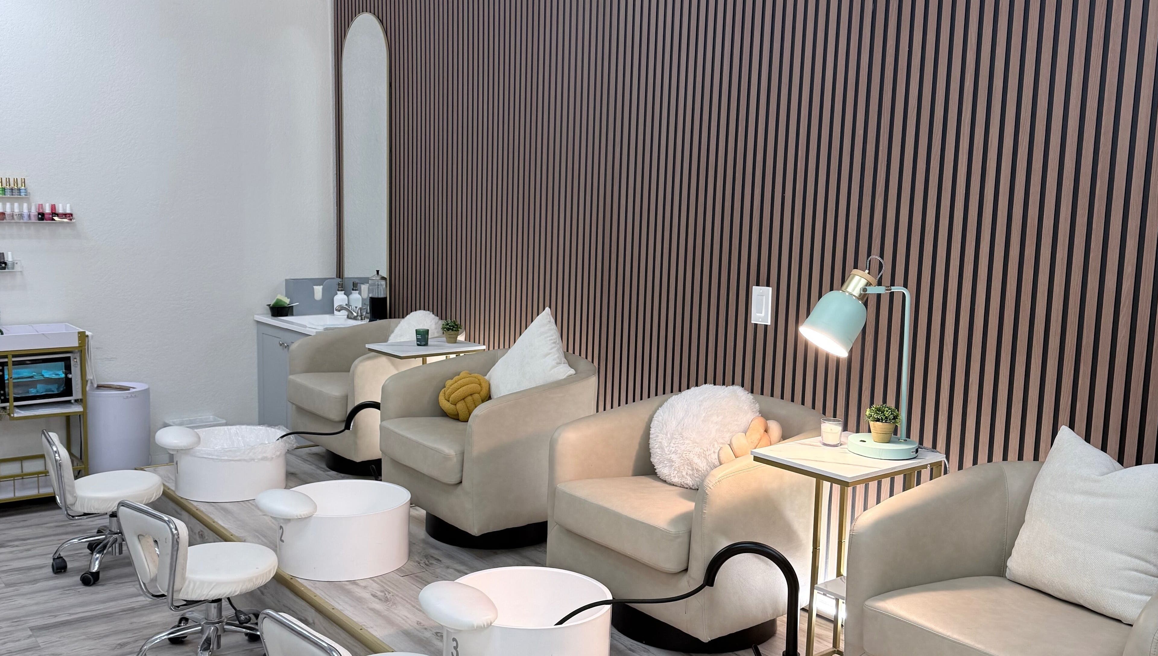 Elegant seating area at Me Nail Spa, Alameda, California, US, featuring plush chairs and modern decor.