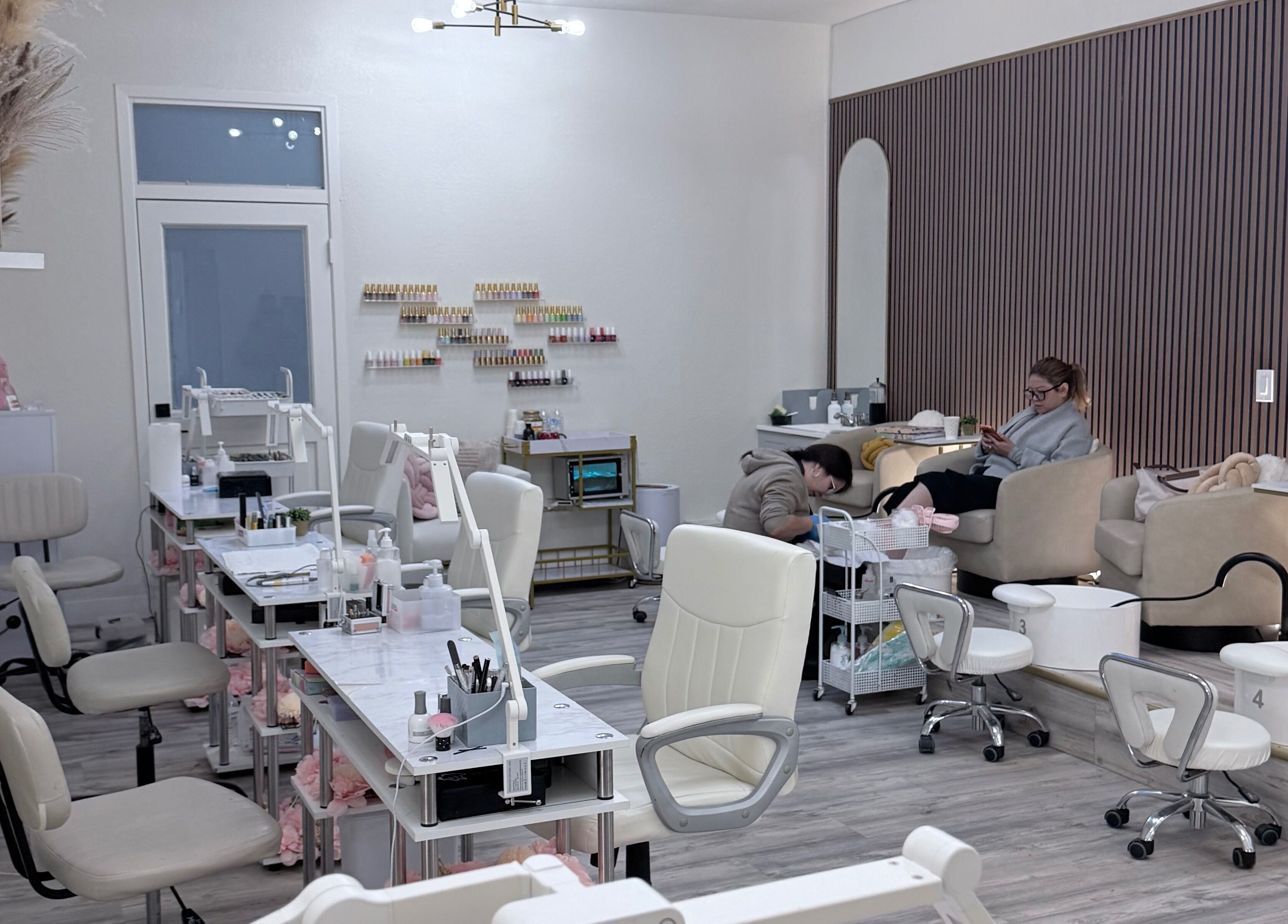 Calm interior of Me Nail Spa in Alameda, California, US showing modern nail stations and relaxing chairs.