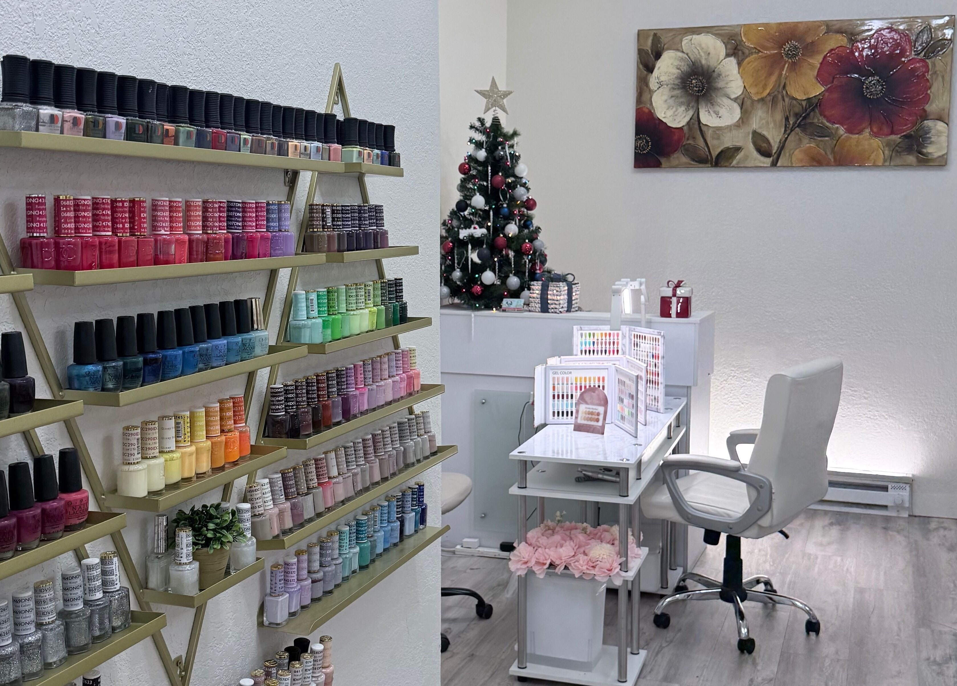 Vibrant nail polish display at Me Nail Spa, Alameda, California, US near a festive decor and seating area.