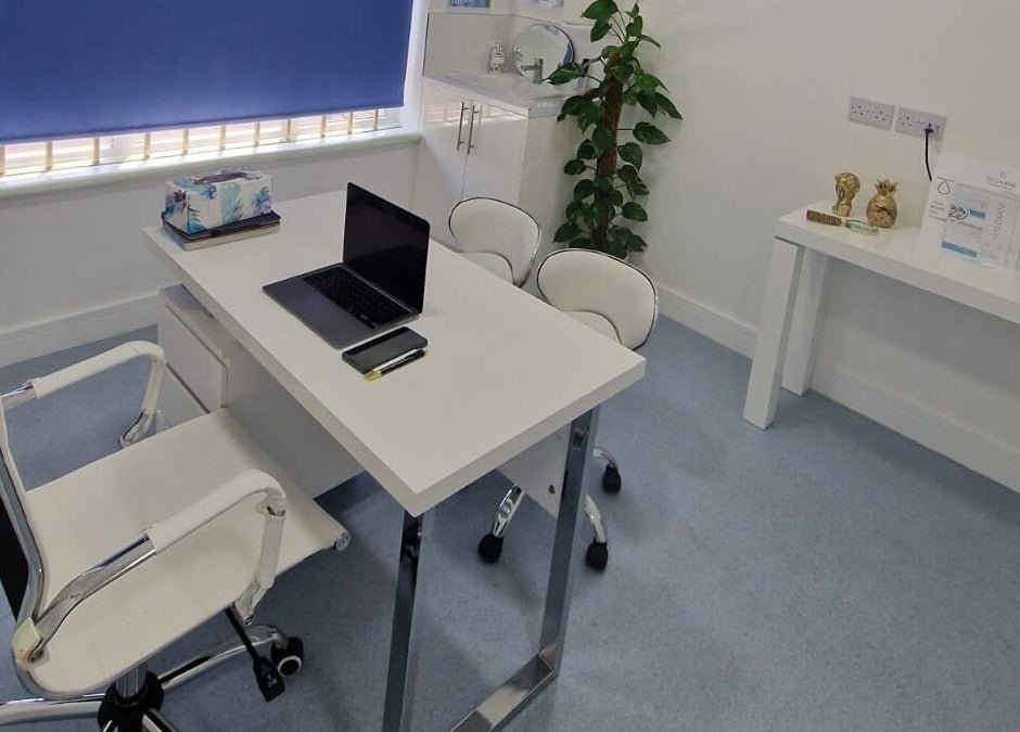 Modern consultation room at Javaani Medical and Aesthetics, Hazlemere, England, GB, featuring sleek furniture.