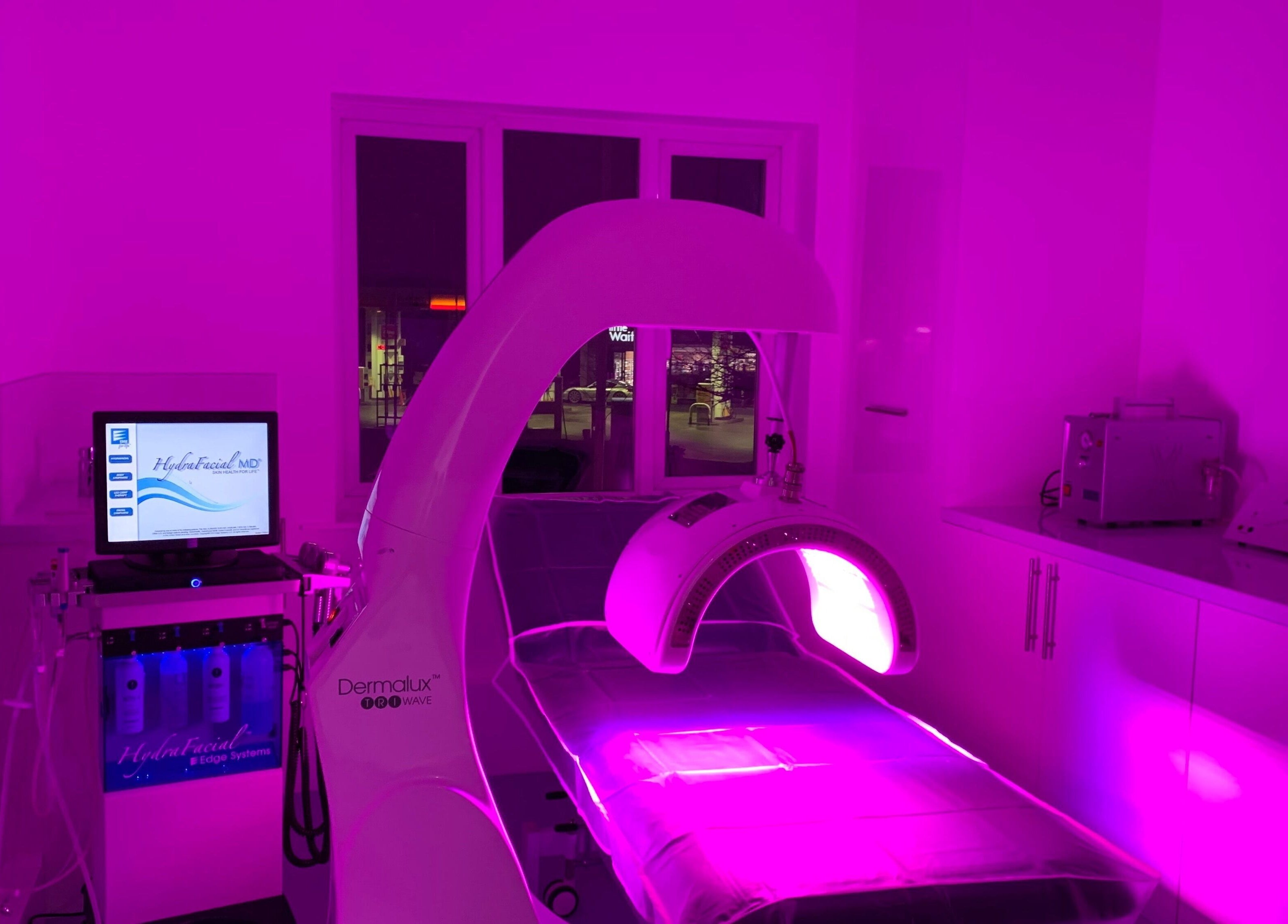 Modern aesthetics room at Javaani Medical and Aesthetics, Hazlemere, England, with vibrant purple lighting.