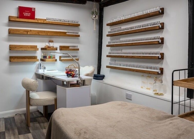 Beautiful You salon's cozy nail room in Bures, England, GB with modern decor and elegant wooden shelves.