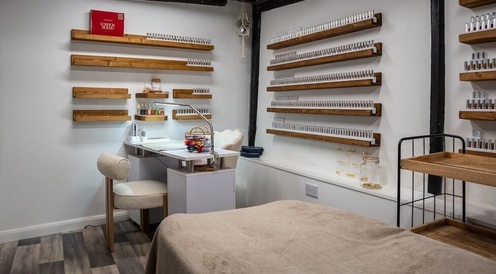 Beautiful You salon's cozy nail room in Bures, England, GB with modern decor and elegant wooden shelves.