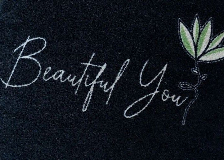 Welcome mat at Beautiful You, Bures, England, GB with elegant lettering and leaf design.