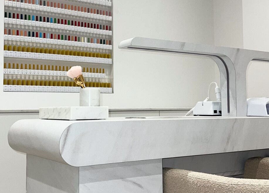 Elegant nail bar at Allure - Jesmond, Newcastle upon Tyne, England, GB with polish display and chic decor.